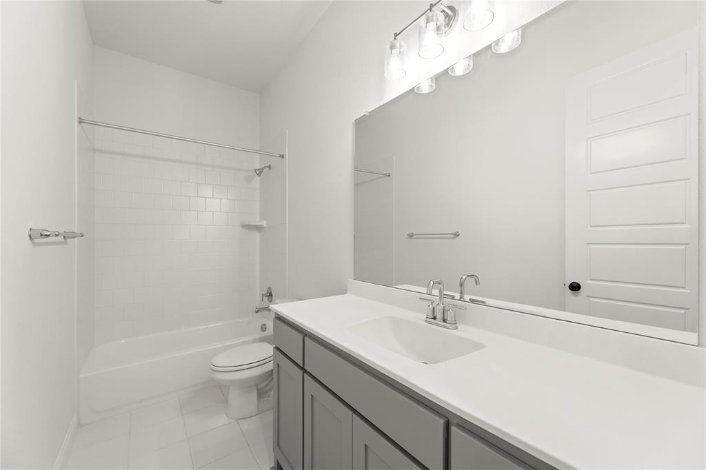 2543 Brunswick Way Allen, TX 75013 - Photo 12 of 38 a bathroom with a sink a toilet and shower