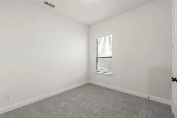 a bathroom with a sink a toilet and a window