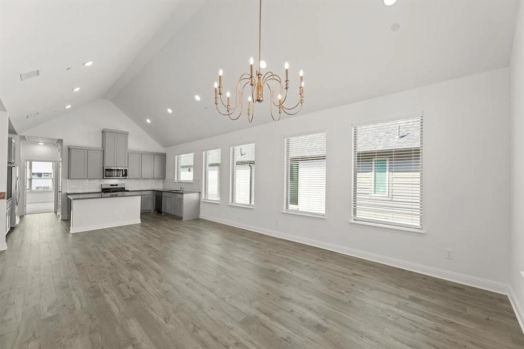 2543 Brunswick Way Allen, TX 75013 - Photo 15 of 38 a view of a kitchen with granite countertop stainless steel appliances cabinets a dining table and a chandelier