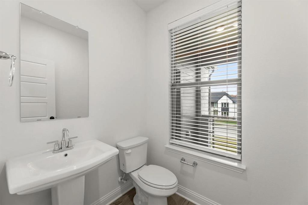 2543 Brunswick Way Allen, TX 75013 - Photo 16 of 34 a bathroom with a sink a toilet and a window