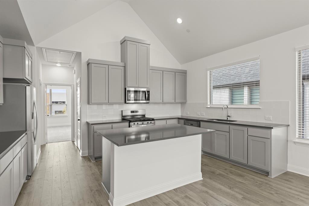 2543 Brunswick Way Allen, TX 75013 - Photo 20 of 34 a kitchen with stainless steel appliances granite countertop a sink stove and refrigerator
