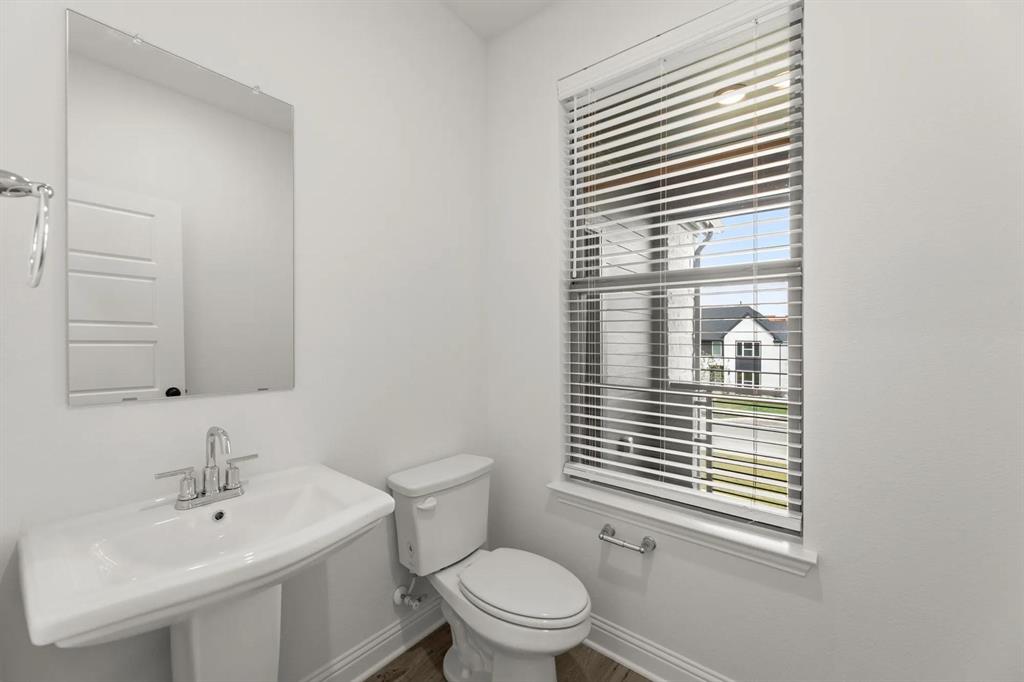 2543 Brunswick Way Allen, TX 75013 - Photo 22 of 38 a bathroom with a sink a toilet and a window