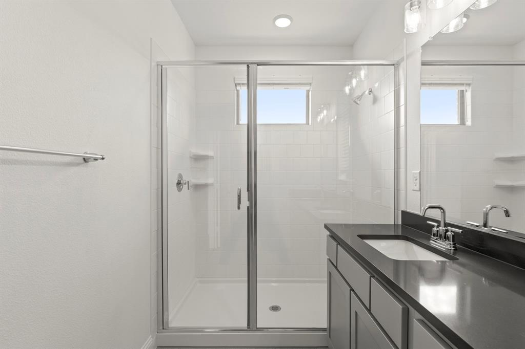 2543 Brunswick Way Allen, TX 75013 - Photo 26 of 34 a bathroom with a sink and a mirror