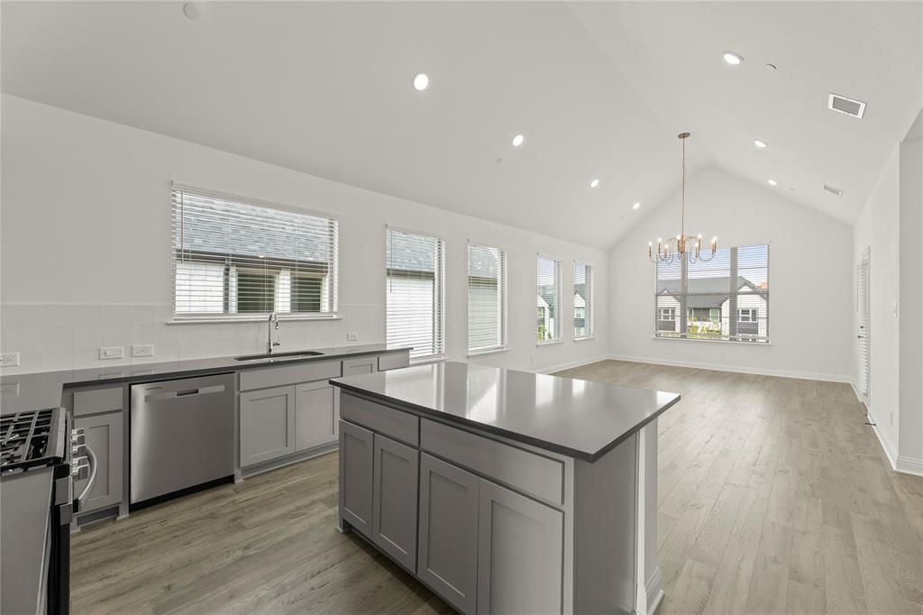 2543 Brunswick Way Allen, TX 75013 - Photo 28 of 38 a kitchen with center island granite countertop a sink and center island