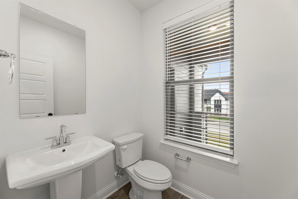 2543 Brunswick Way Allen, TX 75013 - Photo 31 of 34 a bathroom with a sink a toilet and a window