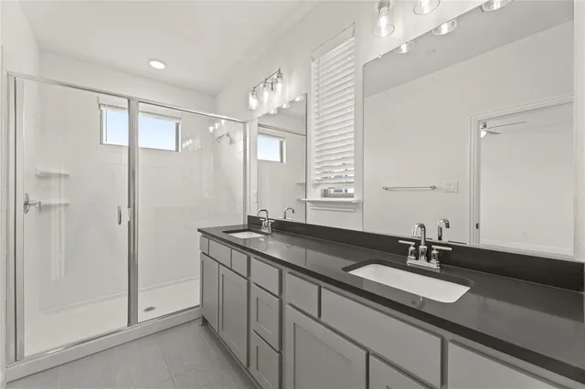 a bathroom with a sink double vanity and a mirror