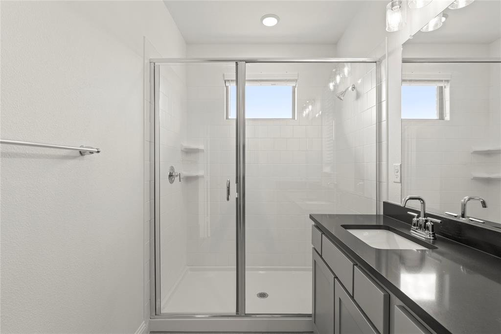 2543 Brunswick Way Allen, TX 75013 - Photo 32 of 38 a bathroom with a sink and a mirror