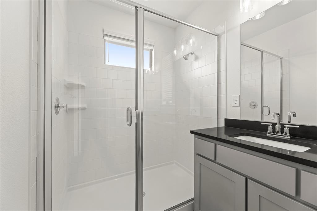 2543 Brunswick Way Allen, TX 75013 - Photo 34 of 38 a bathroom with a granite countertop sink shower and a mirror
