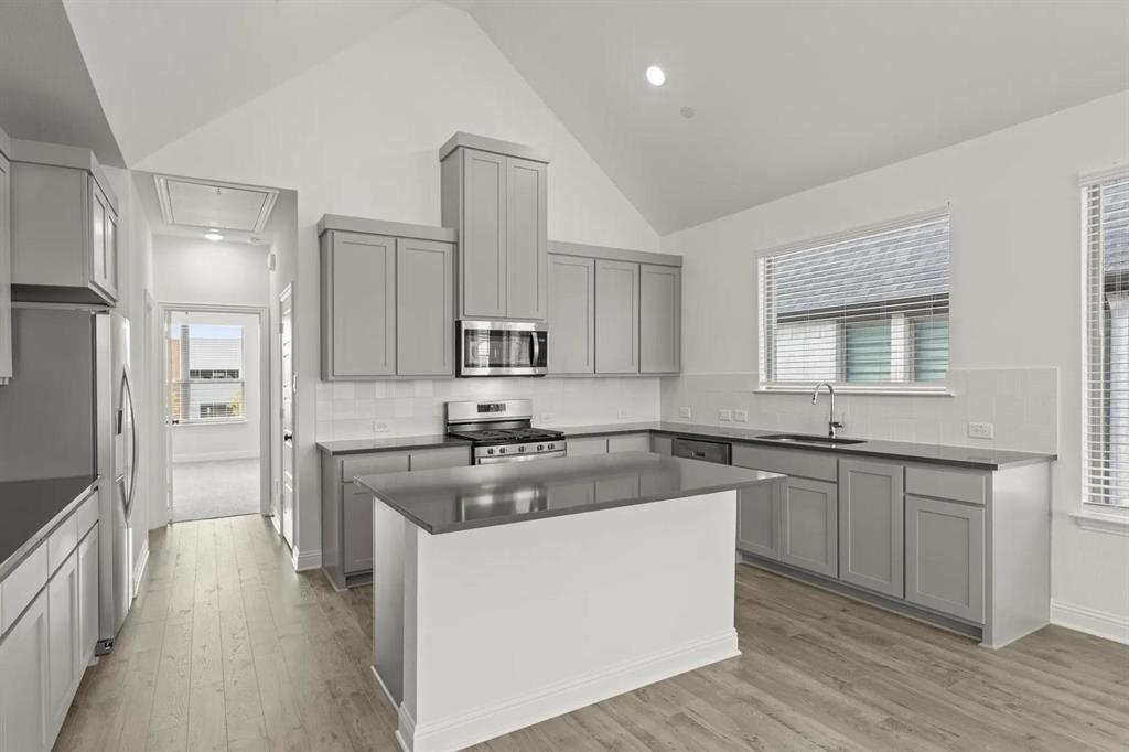 2543 Brunswick Way Allen, TX 75013 - Photo 7 of 34 a kitchen with stainless steel appliances granite countertop a sink stove and refrigerator