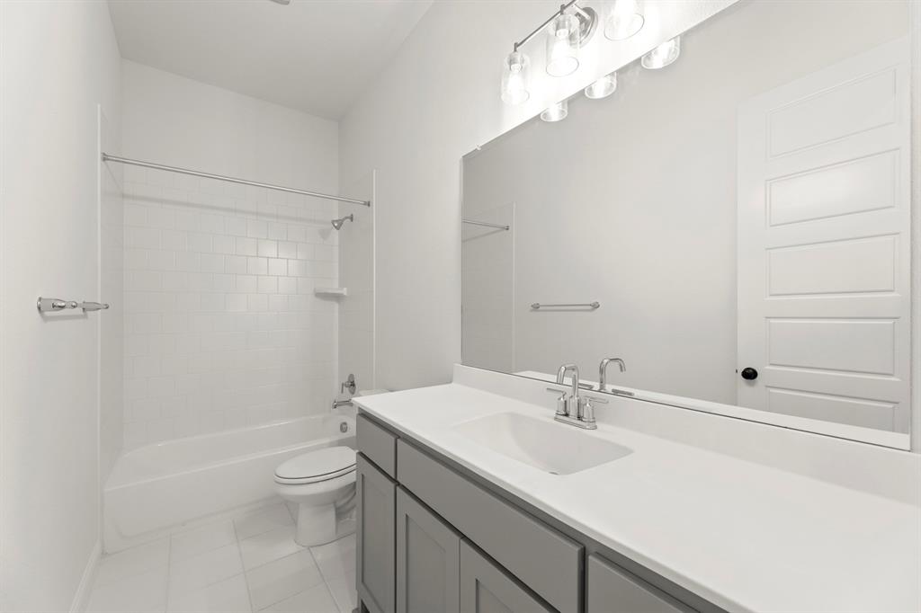 2543 Brunswick Way Allen, TX 75013 - Photo 10 of 34 a bathroom with a sink a toilet and shower