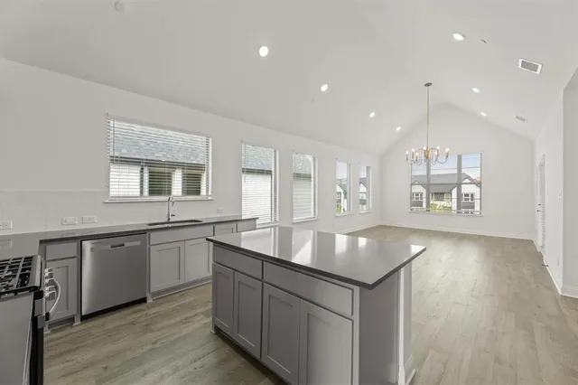 a kitchen with center island granite countertop a sink and center island