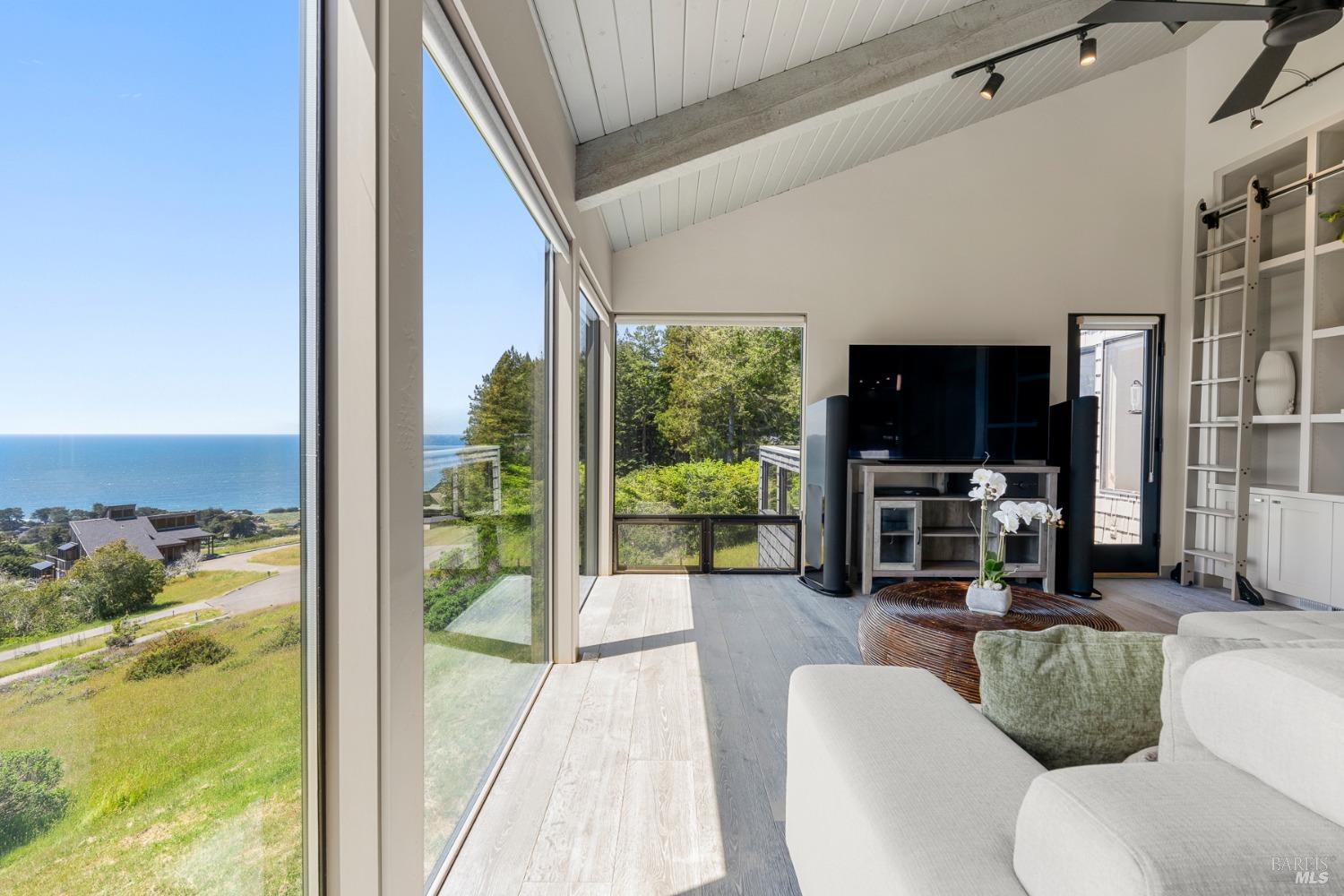 Undisclosed Address The Sea Ranch, CA 95497 - Photo 29 of 46 a living room with furniture tv and floor to ceiling window