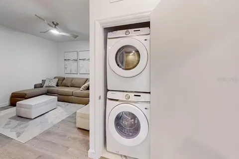 a living room with furniture and a washer dryer