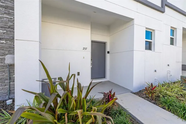 a kitchen with stainless steel appliances kitchen island granite countertop a stove a sink a dining table and chairs