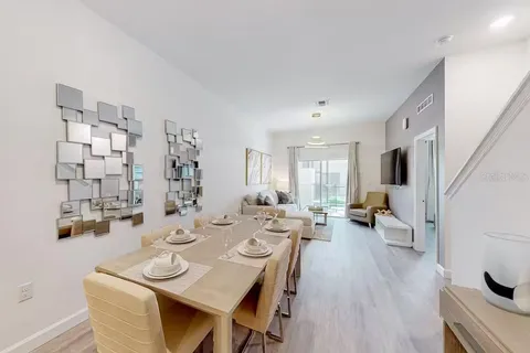 a view of a dining room with furniture window and wooden floor