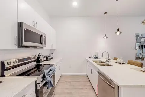 a kitchen that has a sink and a stove