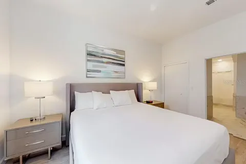 a bedroom with a bed and a night stand