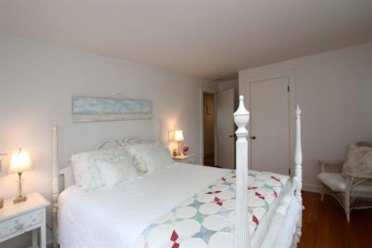 128 Little Neck Bars Road Falmouth, MA 02540 - Photo 16 of 35 a bedroom with a bed and a lamp