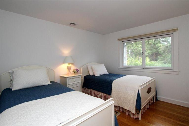128 Little Neck Bars Road Falmouth, MA 02540 - Photo 18 of 35 a hotel room with two beds and a couch
