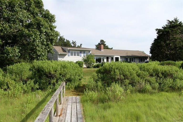 128 Little Neck Bars Road Falmouth, MA 02540 - Photo 21 of 35 a front view of a house with a yard