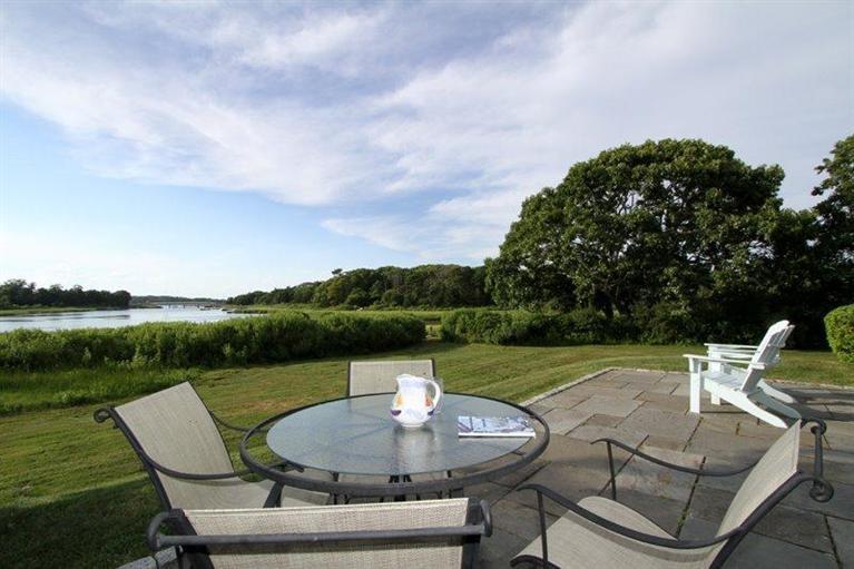 128 Little Neck Bars Road Falmouth, MA 02540 - Photo 24 of 35 a patio with a lake view and mountain view