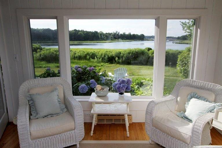128 Little Neck Bars Road Falmouth, MA 02540 - Photo 9 of 35 a living room with furniture and a floor to ceiling window