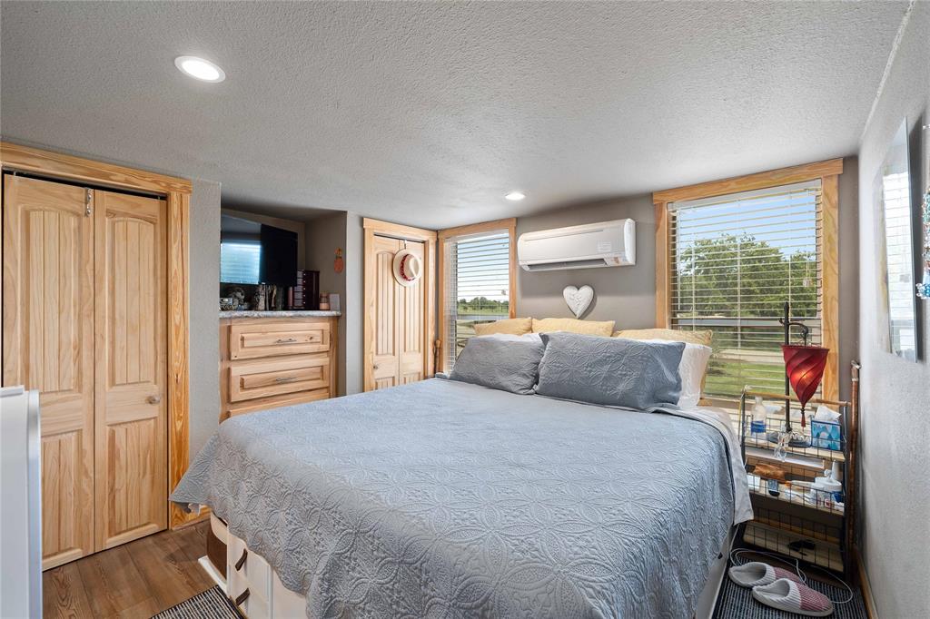 1010 Fm 583 Street West Rising Star, TX 76471 - Photo 39 of 40 a bedroom with a large bed and a large window