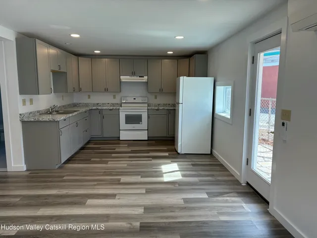 a kitchen with a sink stainless steel appliances and cabinets