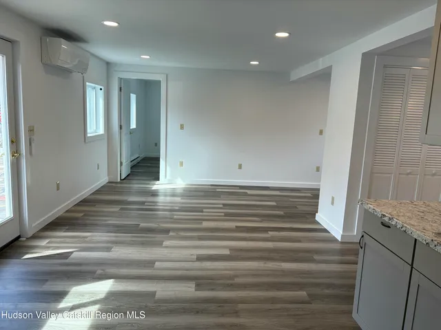 a view of room with cabinets and wooden floor