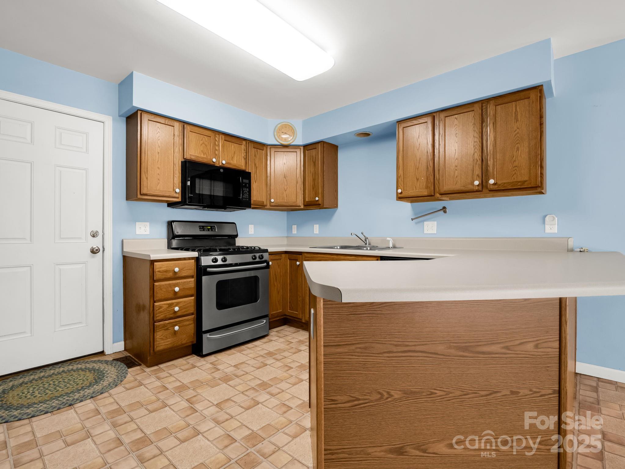 217 Hope Drive Rutherfordton, NC 28139 - Photo 5 of 38 a kitchen with stainless steel appliances granite countertop a stove a sink and a microwave