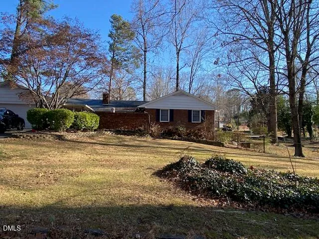 a front view of a house with a yard table and chairs