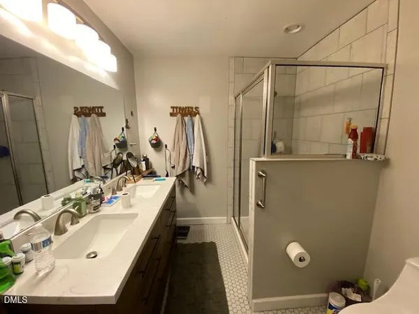 a bathroom with a double vanity sink and mirror