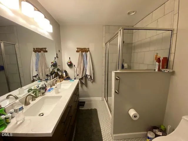 a bathroom with a double vanity sink and mirror