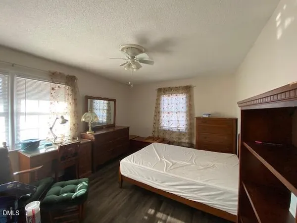 a bedroom with a bed window and couch