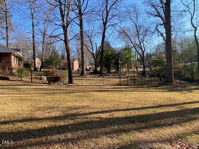 a view of road with large trees