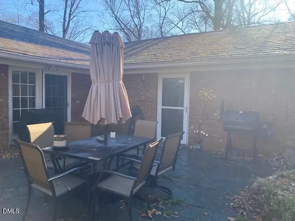 a view of backyard with a table and chairs