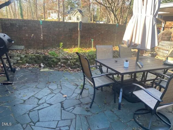 a view of a backyard with a patio and outdoor seating