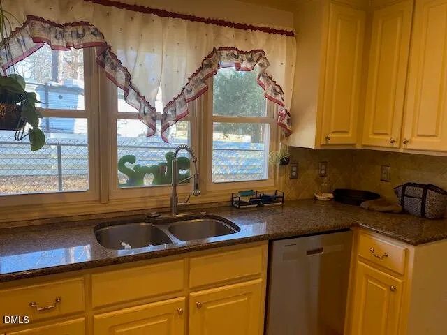 a kitchen with a sink cabinets and a window
