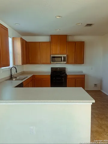 a kitchen with a refrigerator and a sink