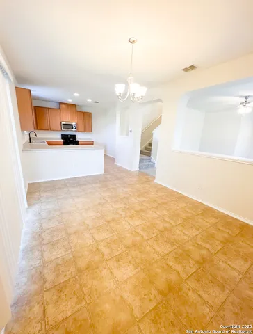 a view of a kitchen with kitchen island and wooden floor