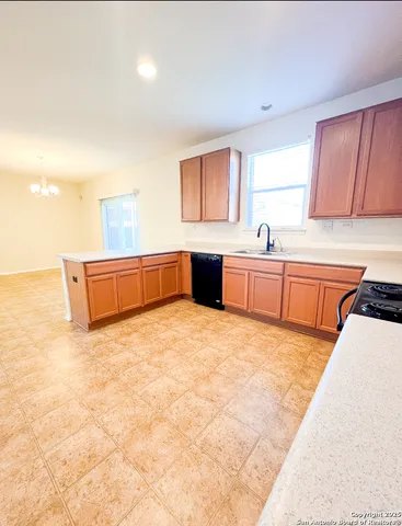 a large white kitchen with cabinets