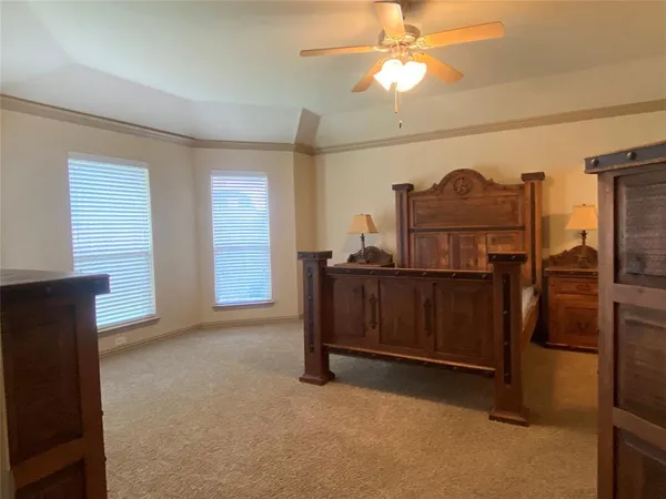 a view of a room with furniture and a ceiling fan
