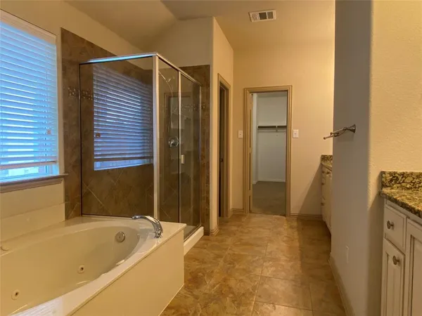 a bathroom with a tub a sink and a shower