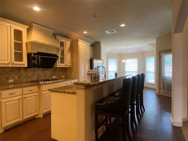 a kitchen with a table chairs sink and microwave