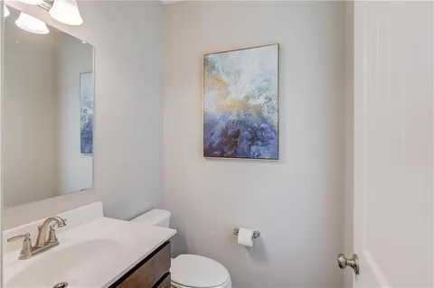 a bathroom with a sink mirror and toilet