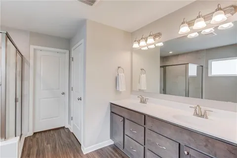 a bathroom with a double vanity sink and a mirror