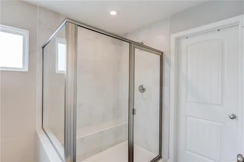 a bathroom with a glass door shower