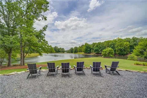 a view of a lake with outdoor seating