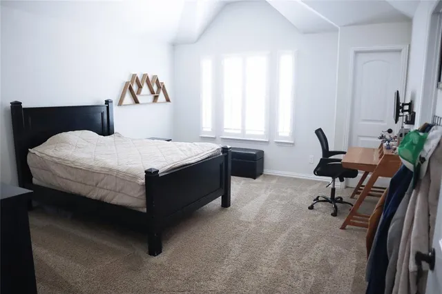 a bed room with a bed and a chair