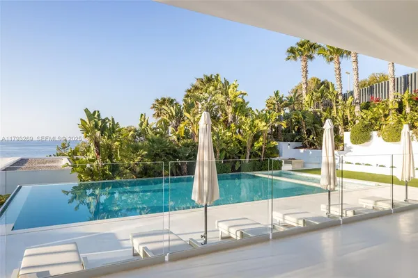 a view of a patio with a dining table and chairs